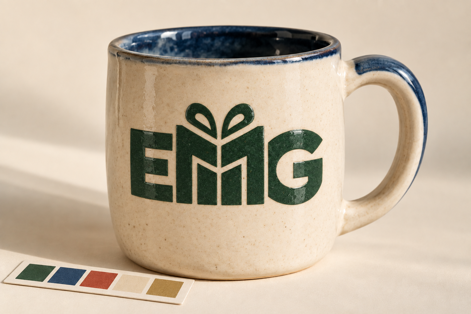 EMG raised gloss mark on a glazed ceramic mug beside a five-color control strip